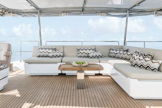 Relax on the spacious deck of this yacht, complete with comfortable seating and a beautiful ocean view.