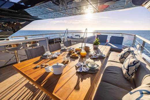 Enjoy a leisurely breakfast on deck as the sun glints off the tranquil ocean waters.