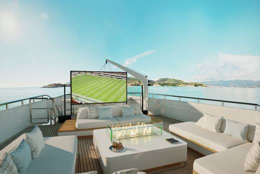 Enjoy a soccer match on a giant screen while relaxing on a luxurious yacht deck overlooking the Mediterranean.