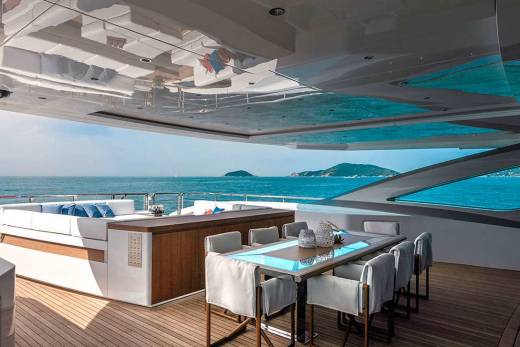 A luxurious yacht deck offers a serene dining experience with stunning ocean views and comfortable seating.