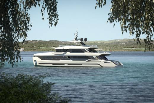 A sleek, modern yacht glides through tranquil turquoise waters, framed by lush green foliage.