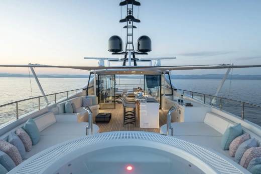 Relax in the onboard jacuzzi and enjoy the serene ocean views from this luxurious yacht deck.