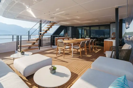 Enjoy al fresco dining and lounging on the expansive deck of this luxurious yacht with stunning mountain and sea views.