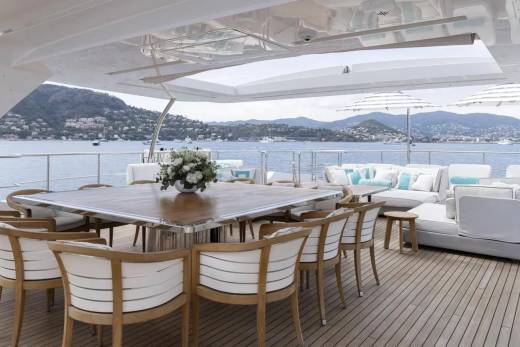 Dine al fresco on the spacious deck of this luxurious yacht, surrounded by stunning coastal views.