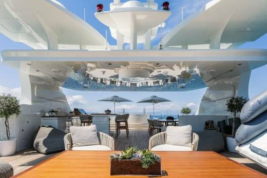Relax on the luxurious deck of this yacht, complete with plush seating, a hot tub, and stunning ocean views.