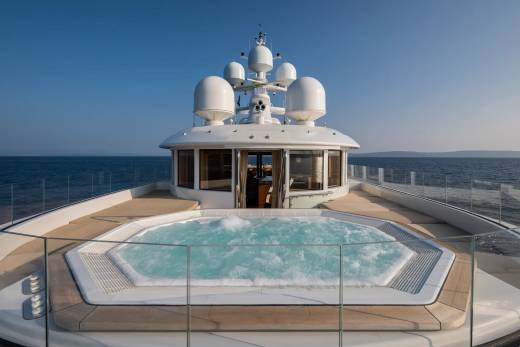 Soak in the bubbling jacuzzi on the deck of this luxurious yacht, surrounded by the endless blue of the ocean.