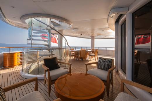 Relax on the deck of this luxurious yacht, enjoying the ocean breeze and stunning views.