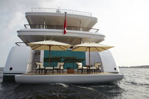 The luxurious Lady Christine yacht offers a serene deck with comfortable seating and umbrellas for a relaxing day at sea.