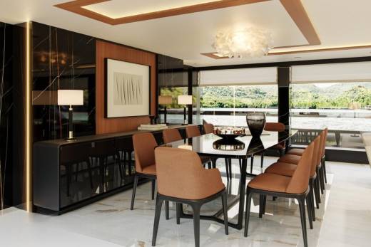A luxurious dining room with a sleek black table and plush brown chairs offers stunning views of a serene waterfront landscape.