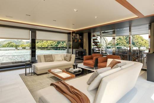 Luxurious yacht interiors offer stunning panoramic views of lush green islands and tranquil waters.