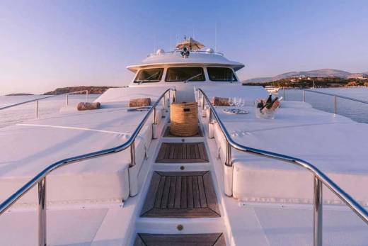 Luxurious yacht deck awaits with chilled champagne and stunning coastal views at sunset.