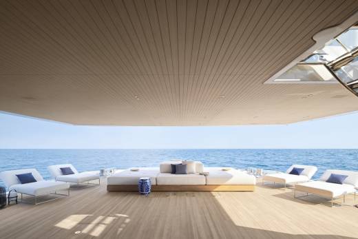 Relax on the spacious deck of a luxury yacht, surrounded by the serene blue ocean and modern comfort.