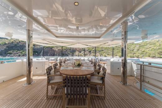 Dine al fresco on the spacious deck of this luxurious yacht, surrounded by stunning coastal scenery.