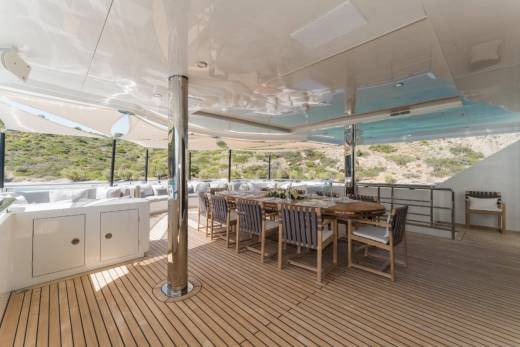 Dine al fresco on the spacious deck of this luxurious yacht, surrounded by stunning coastal views.