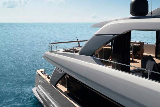 A luxurious white yacht with sleek lines and modern design sits atop the serene, azure waters of the ocean, offering a breathtaking view of the horizon.