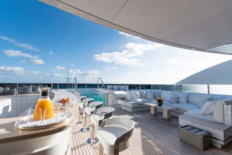 Enjoy a refreshing drink and a light breakfast on the spacious deck of this luxurious yacht, overlooking the sparkling blue ocean.