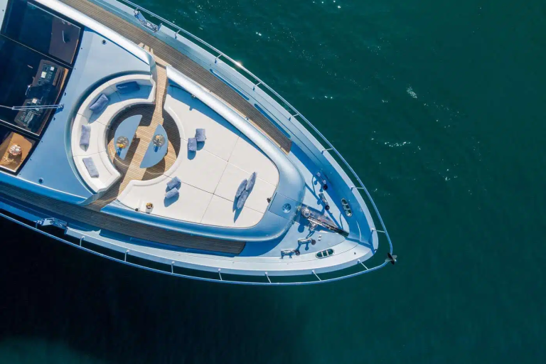 A large, sleek yacht with a distinctive design sits atop the deep blue waters, surrounded by a serene and tranquil environment.