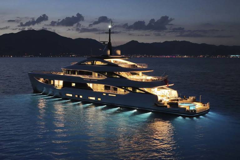 A luxurious yacht glows with interior lights and underwater illumination while anchored in calm waters at dusk.