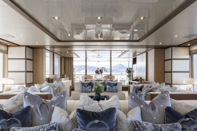Luxurious yacht interiors blend plush comfort with breathtaking ocean views through expansive windows.