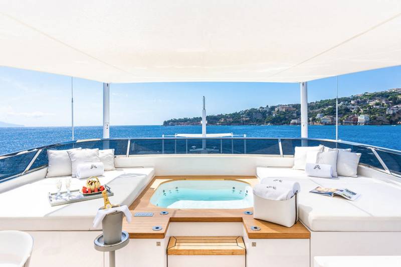 Relax in the jacuzzi on this luxurious yacht while enjoying the stunning coastal views.