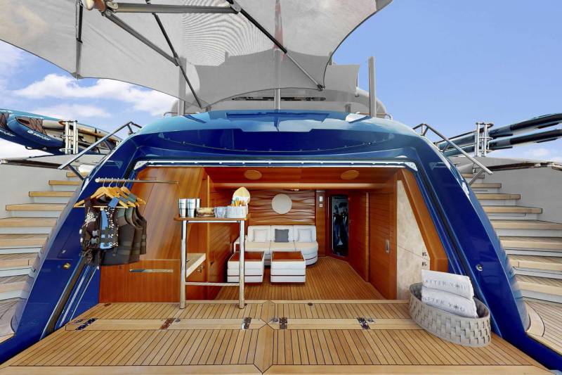 Luxurious yacht amenities include a comfortable seating area, life vests, and paddleboards ready for adventure.