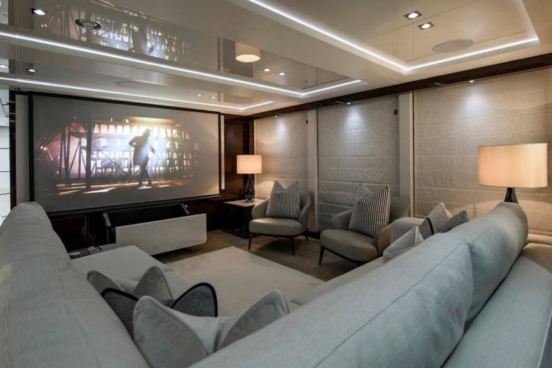 Relax in this luxurious yacht cinema, complete with a large screen and plush seating.