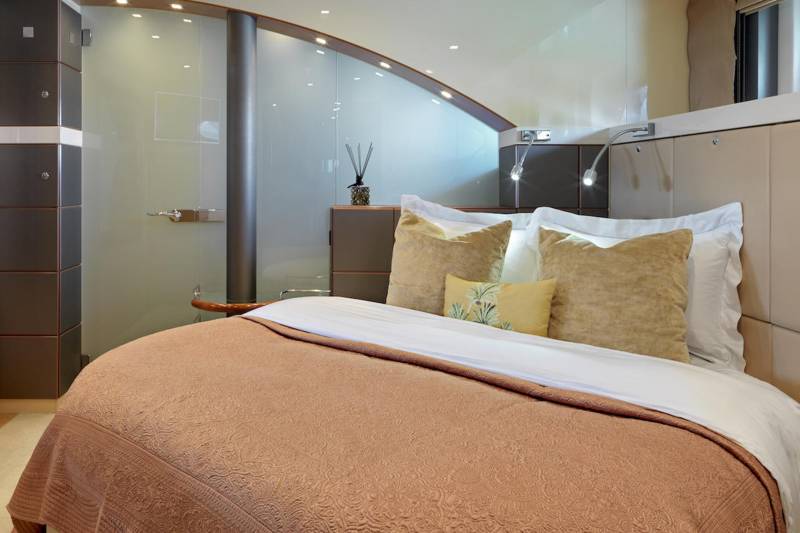 Luxurious bedding and elegant design create a serene retreat within this modern yacht cabin.