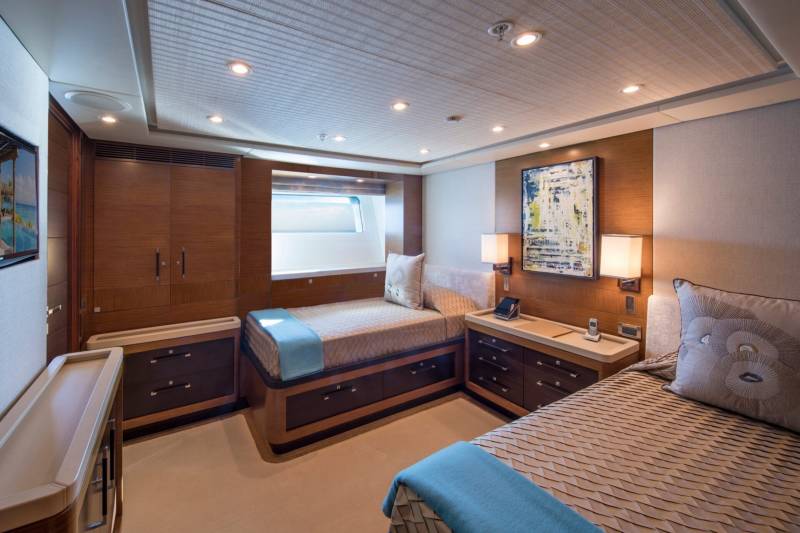 Luxurious twin beds with plush bedding and a calming blue throw invite restful slumber in this elegantly appointed cabin.