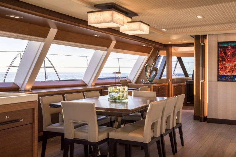 Dine in elegant comfort aboard this luxurious yacht, with panoramic ocean views framing the sophisticated dining area.