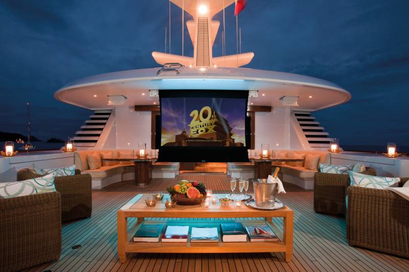 Enjoy an al fresco movie night under the stars on this luxurious yacht's deck, complete with champagne and a fruit platter.