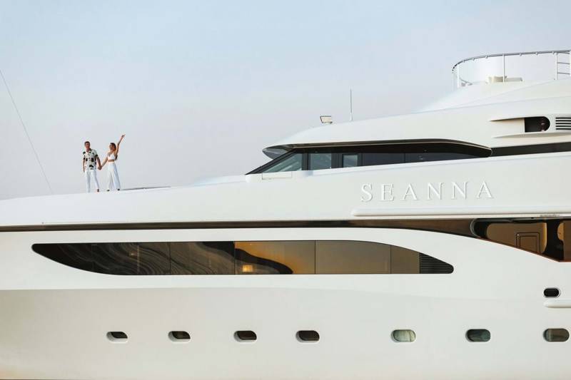 A couple celebrates on the deck of the luxurious yacht Seanna, enjoying a breathtaking ocean view.