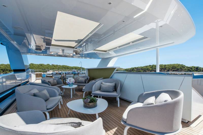 Relax on the plush seating of this luxurious yacht deck, surrounded by the serene beauty of the Mediterranean coast.