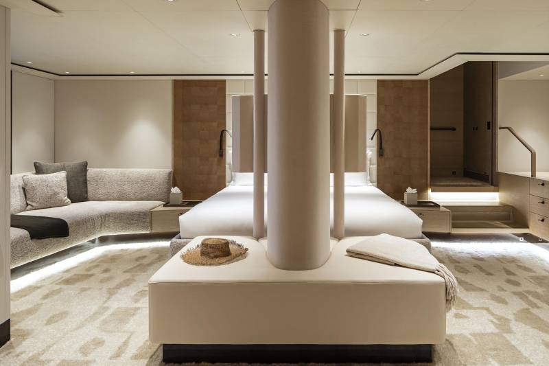 Luxurious yacht interiors feature a plush bed, comfortable seating, and elegant wooden accents for ultimate relaxation.