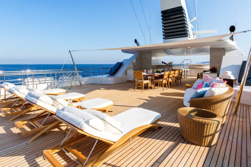 Relax on the sun-drenched deck of this luxurious yacht, surrounded by the serene blue of the ocean.