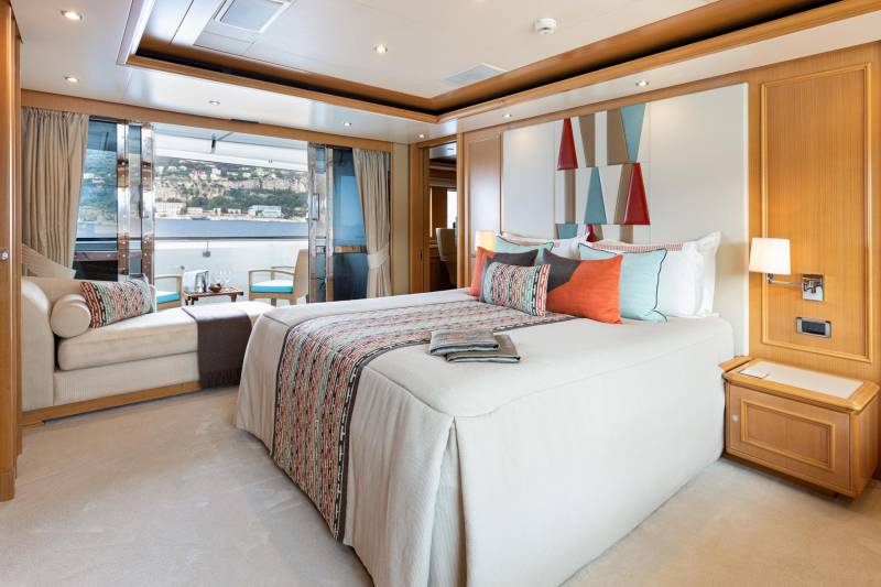 Luxurious yacht stateroom offers a serene retreat with stunning ocean views and elegant decor.