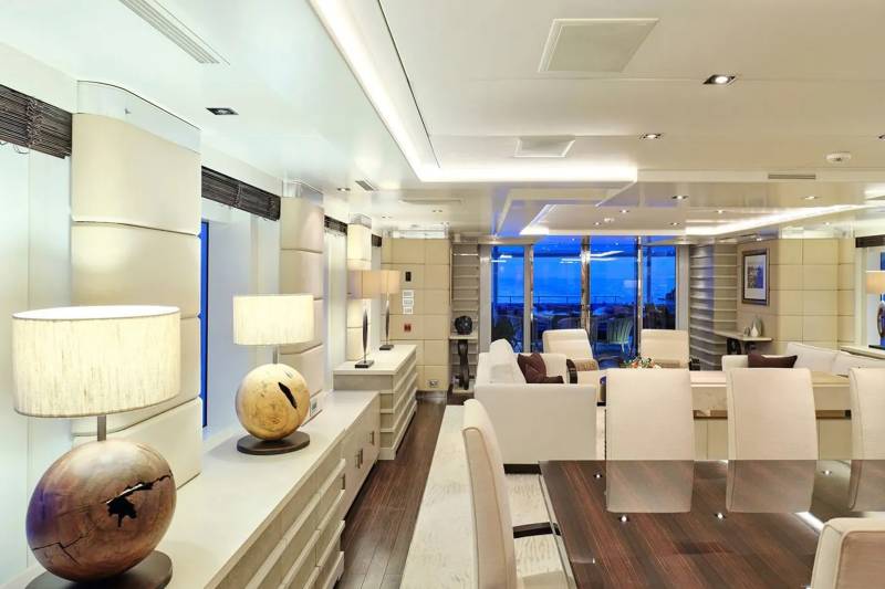 Luxurious yacht interiors offer stunning ocean views through expansive windows.