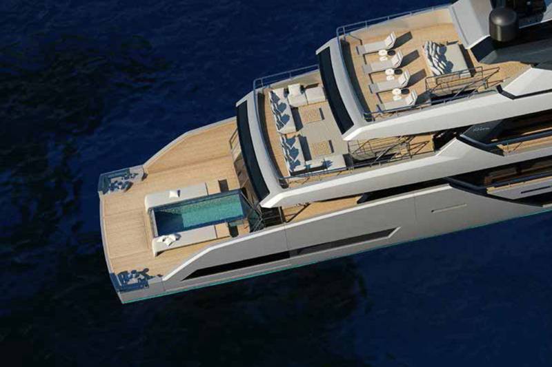 A luxurious yacht with a pristine pool and ample deck space glides through deep blue waters.