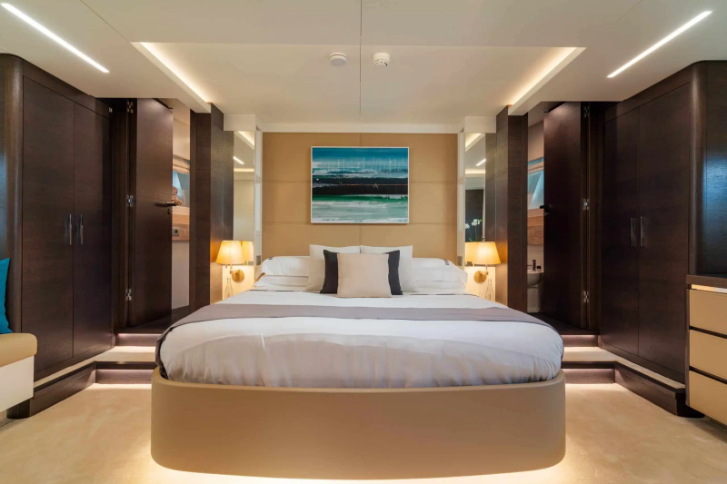 A modern and well-appointed bedroom with a large bed, dark wood furniture, and a vibrant abstract painting on the wall, creating a serene and inviting atmosphere.