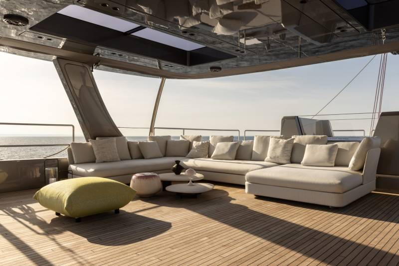 Relax on the luxurious deck of a yacht, enjoying the serene ocean view from the plush sectional sofa.