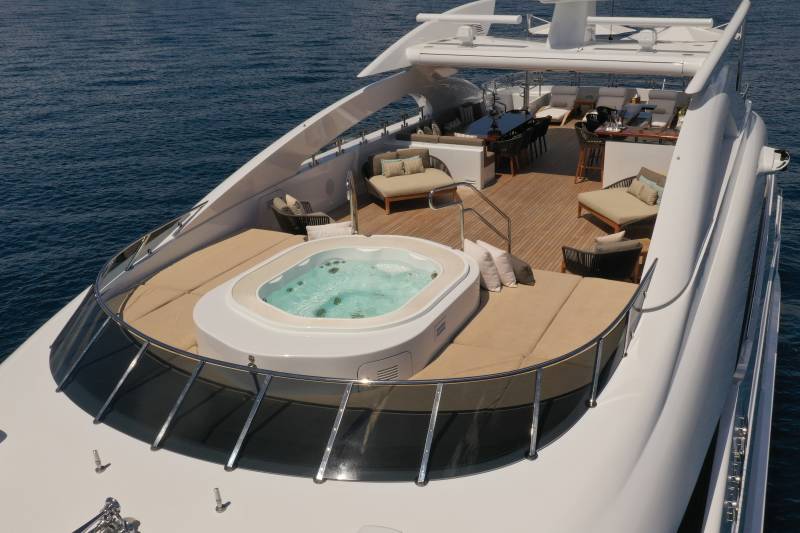 Relax in the bubbling hot tub on the deck of this luxurious yacht as the ocean waves gently lap the hull.