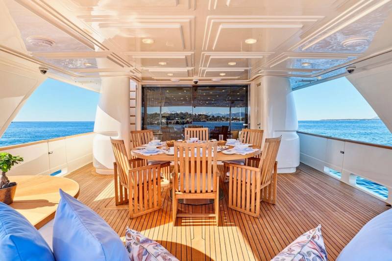 Dine al fresco on the spacious deck of this luxurious yacht, surrounded by the sparkling blue sea.