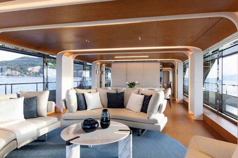 Luxurious yacht interiors blend seamlessly with breathtaking ocean views through expansive windows.