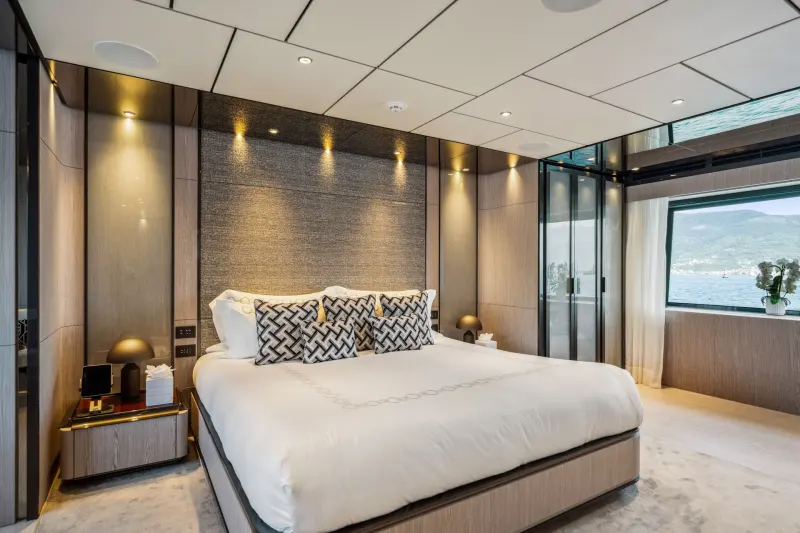 Luxurious yacht bedroom offers stunning ocean views and elegant, modern design.