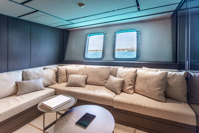 Relax in this cozy lounge area with ocean views through the porthole windows.
