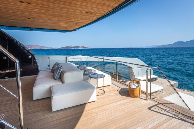 Relax on the spacious deck of this luxurious yacht, enjoying the endless blue sea and distant islands.