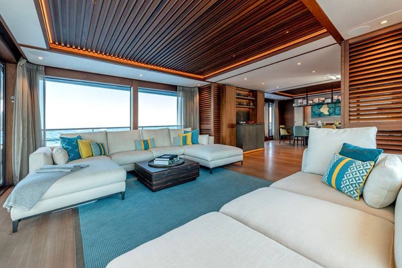 Luxurious yacht interiors feature plush seating and panoramic ocean views, creating a serene and elegant living space.