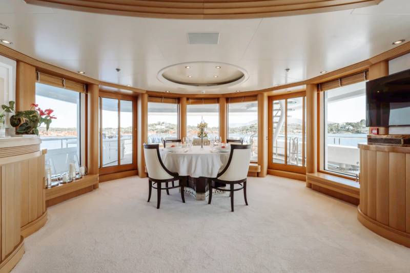 Dine in elegance surrounded by panoramic views of the azure sea from this luxurious yacht dining salon.
