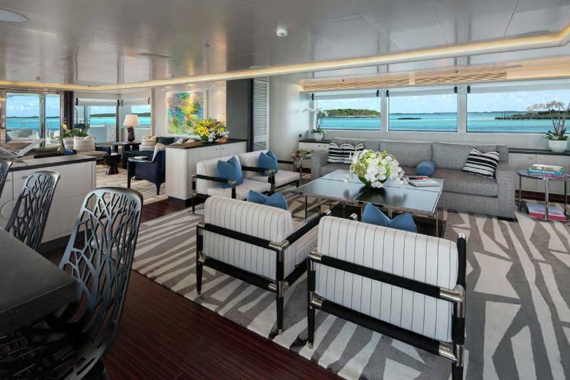 Luxurious yacht interiors offer stunning ocean views through expansive windows.