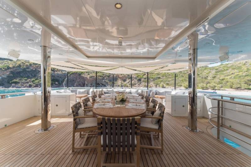 Dine al fresco on the spacious deck of this luxurious yacht, surrounded by stunning coastal scenery.
