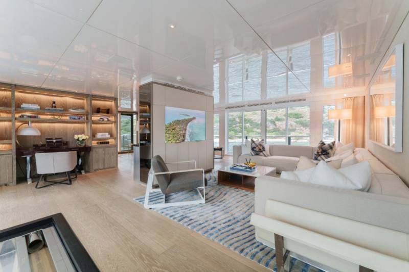 Luxurious yacht interiors offer a serene retreat with ample natural light and sophisticated furnishings.